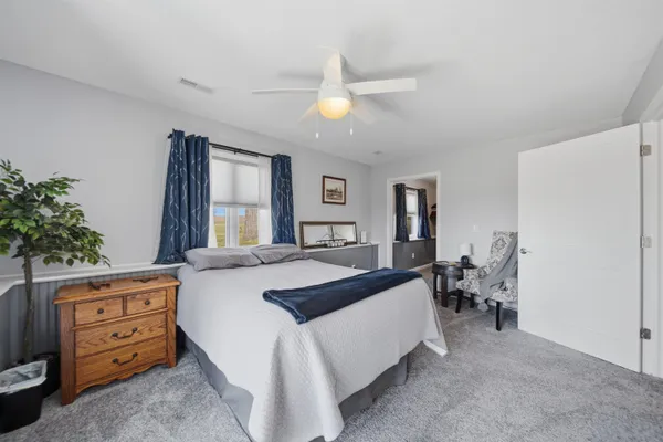 a bed room with a bed and a chandelier
