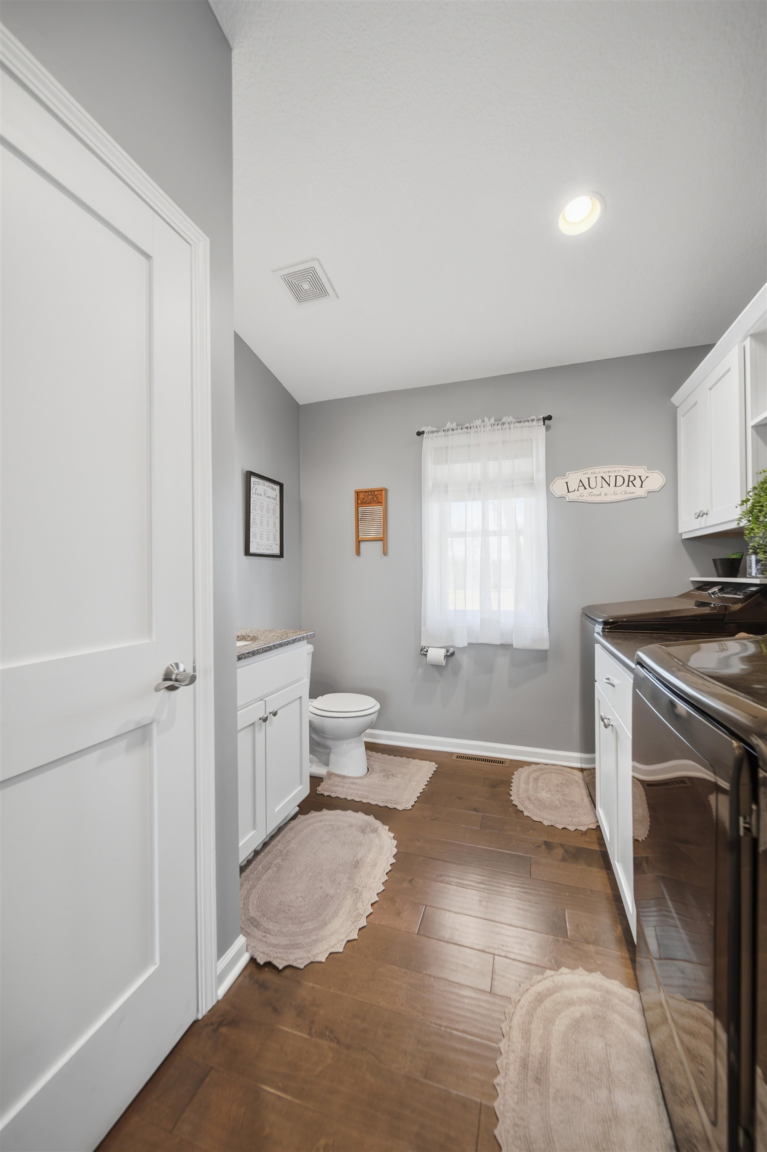 5287 East Canfield (5 Ac) Road Chana, IL 61015 - Photo 10 of 45 a spacious bathroom with a granite countertop sink a toilet and a window