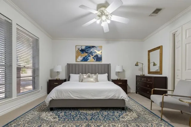 a bedroom with a bed a couch and a window