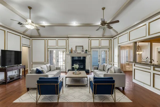 a living room with furniture a fireplace and a flat screen tv