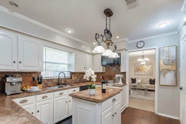 a kitchen with a center island appliances and cabinets