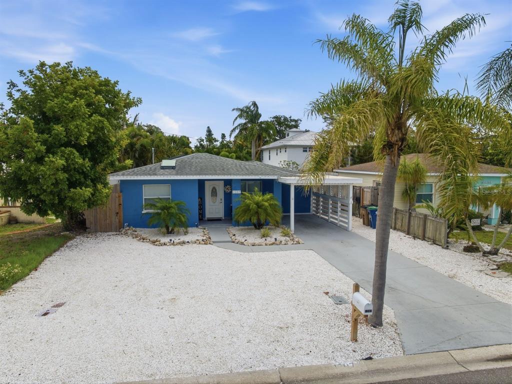 1207 1st Street Indian Rocks Beach, FL 33785 - Photo 40 of 60 a front view of a house with a yard and tree