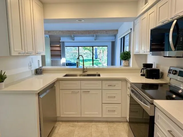 a kitchen with a sink stove and microwave