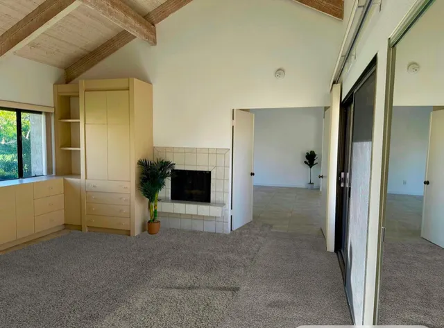 a view of an empty room and a fireplace