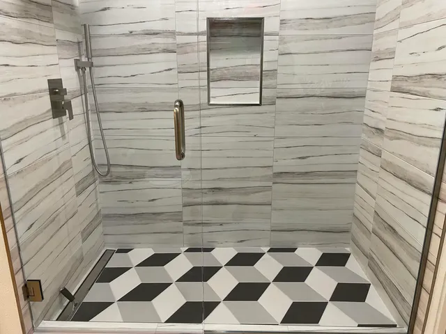 a bathroom with a black and white checkered floor