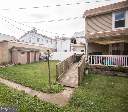 a view of a house with a yard and deck