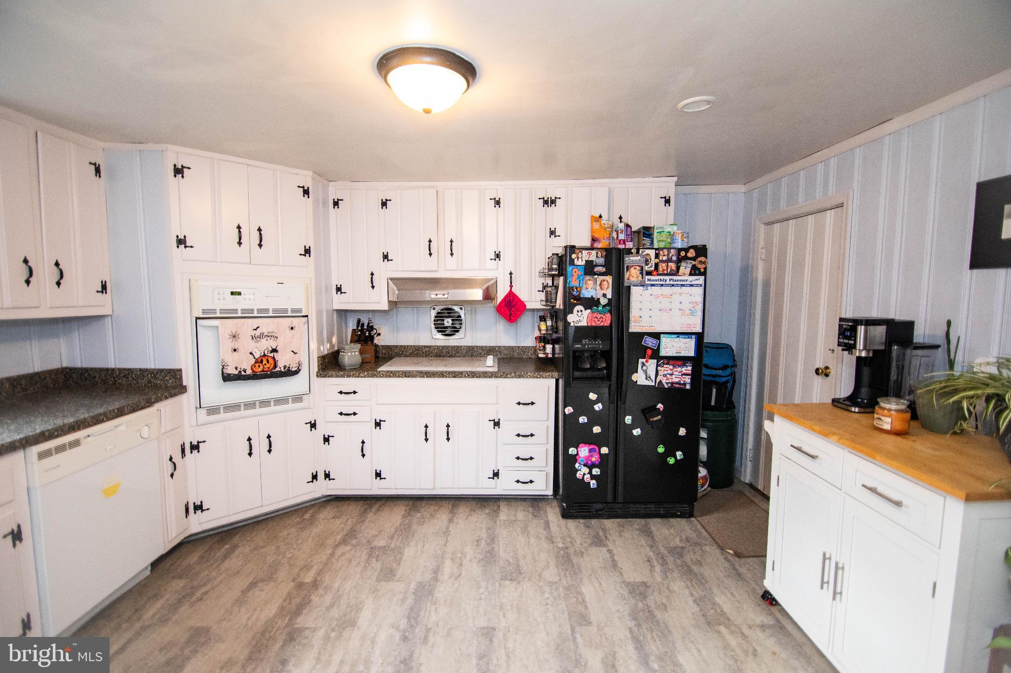 12 South 3rd Street Newport, PA 17074 - Photo 6 of 12 a kitchen with stainless steel appliances a stove top oven a refrigerator a sink and white cabinets