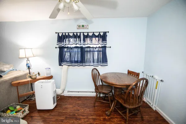 a view of a dining room with furniture and wooden floor