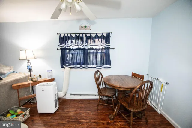 a view of a dining room with furniture and wooden floor