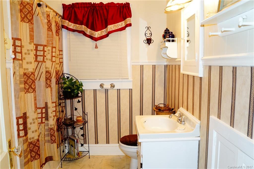 1396 Springdale Road, Unit 4/A Lancaster, SC 29720 - Photo 19 of 23 a bathroom with a sink and mirror with shower