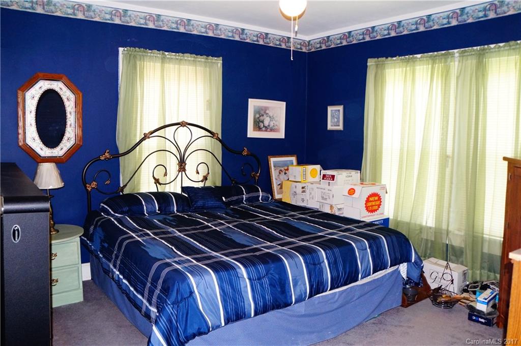 1396 Springdale Road, Unit 4/A Lancaster, SC 29720 - Photo 21 of 23 a bedroom with bed and a chandelier