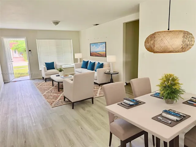 a living room with couches and a table with wooden floor