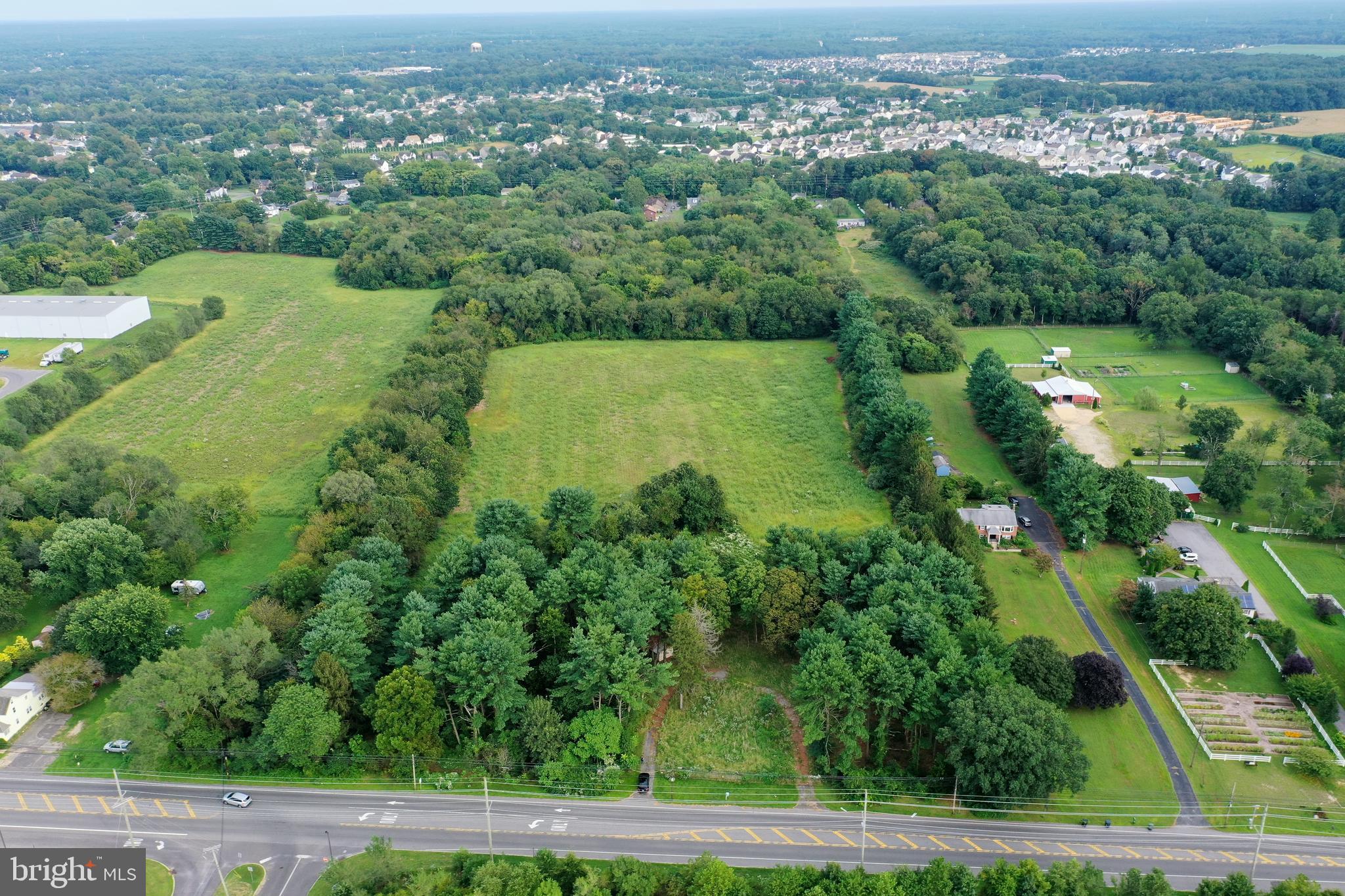 632 Clayton Road Williamstown, NJ 08094 - Photo 7 of 18 an aerial view of green landscape with trees houses and lake view