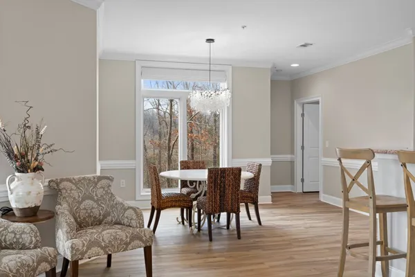 a view of a dining room with furniture window and wooden floor