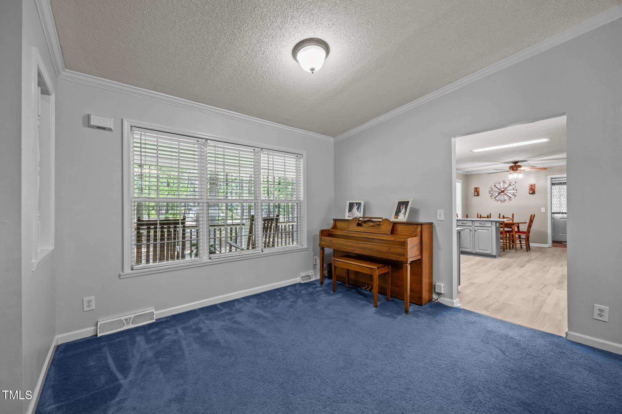 117 Lema Drive Garner, NC 27529 - Photo 10 of 34 a bedroom with furniture and a large window