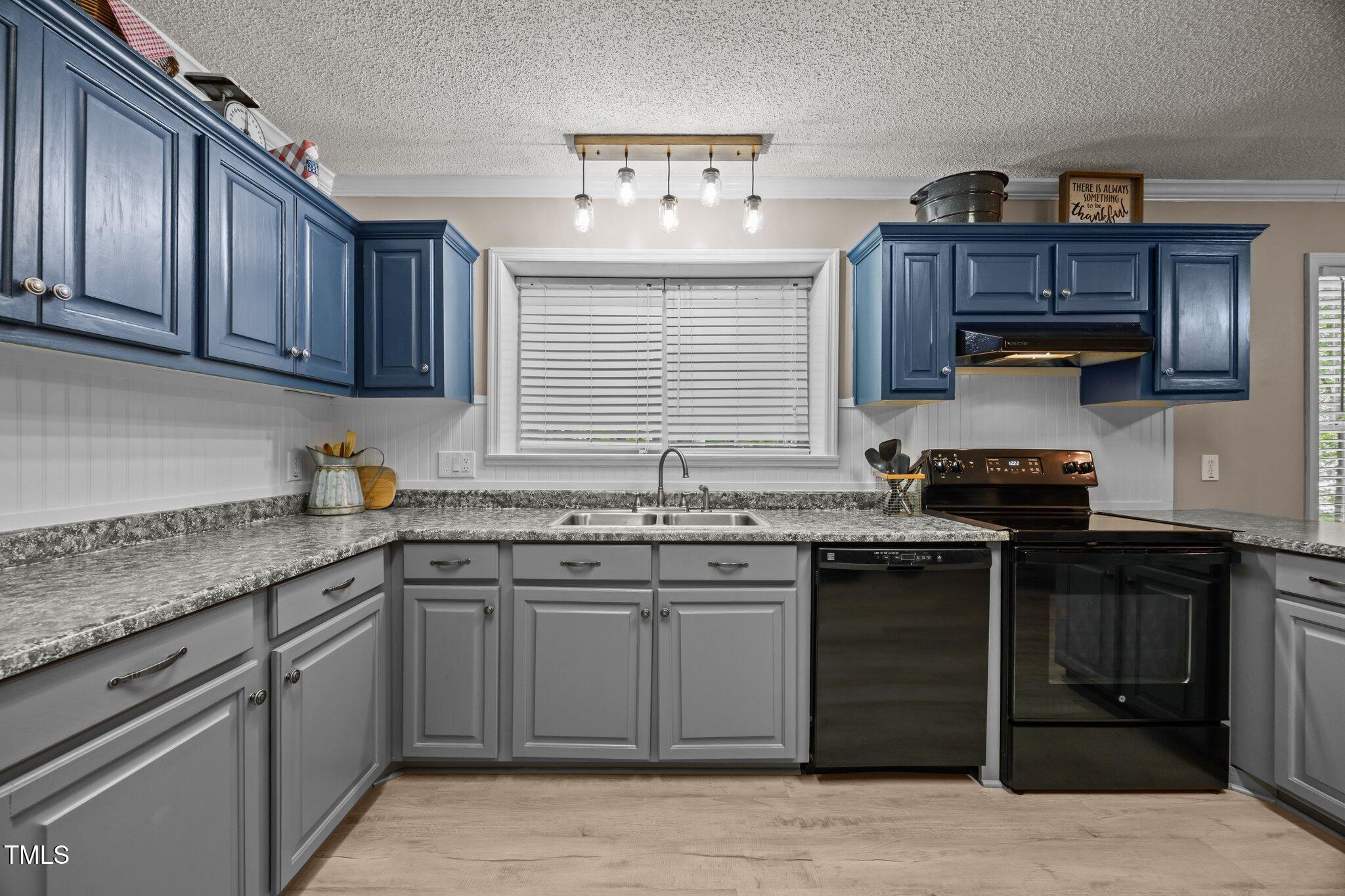 117 Lema Drive Garner, NC 27529 - Photo 12 of 34 a kitchen with stainless steel appliances granite countertop a stove sink and cabinets