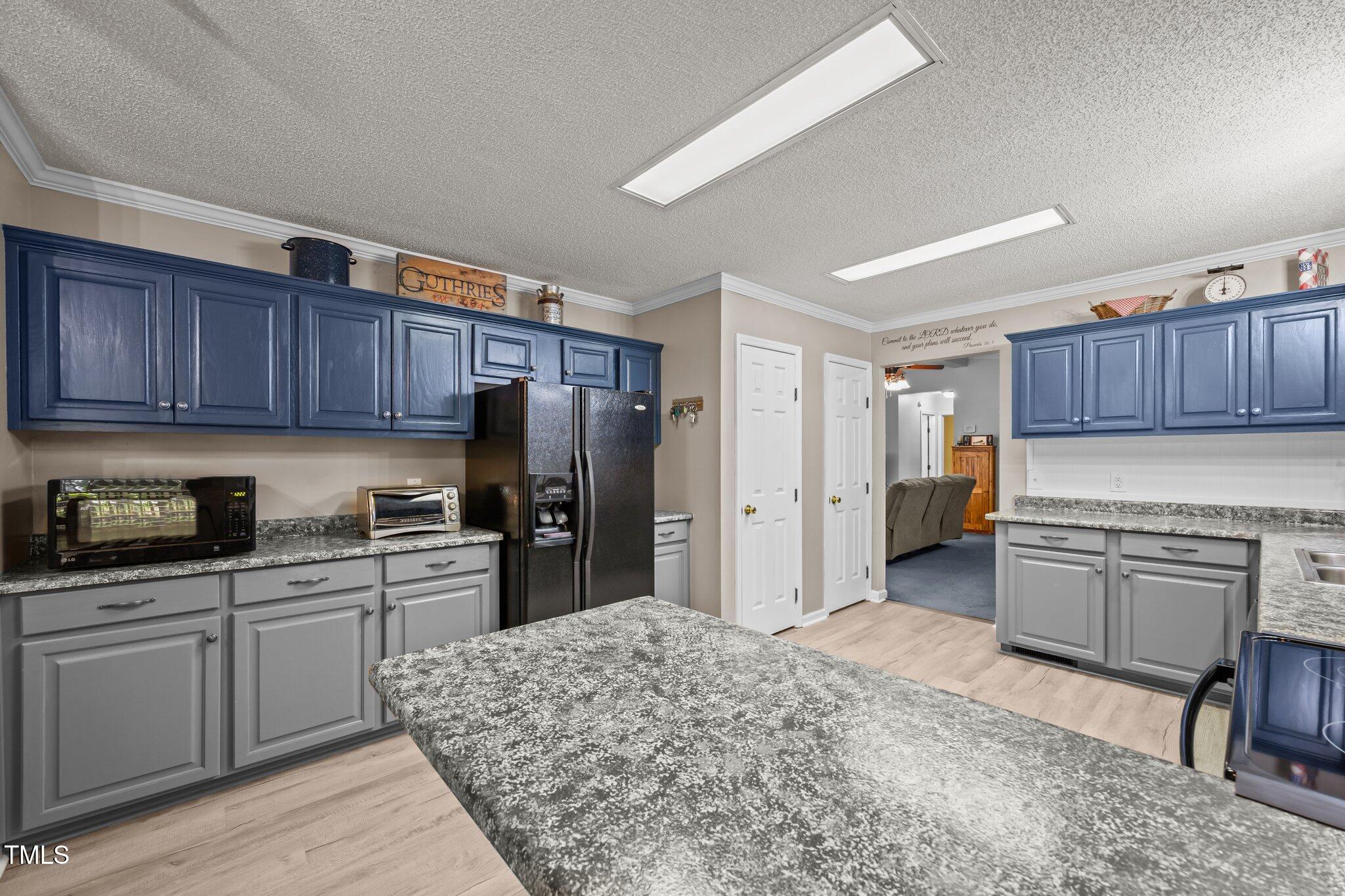 117 Lema Drive Garner, NC 27529 - Photo 14 of 34 a kitchen with granite countertop wooden cabinets and stainless steel appliances