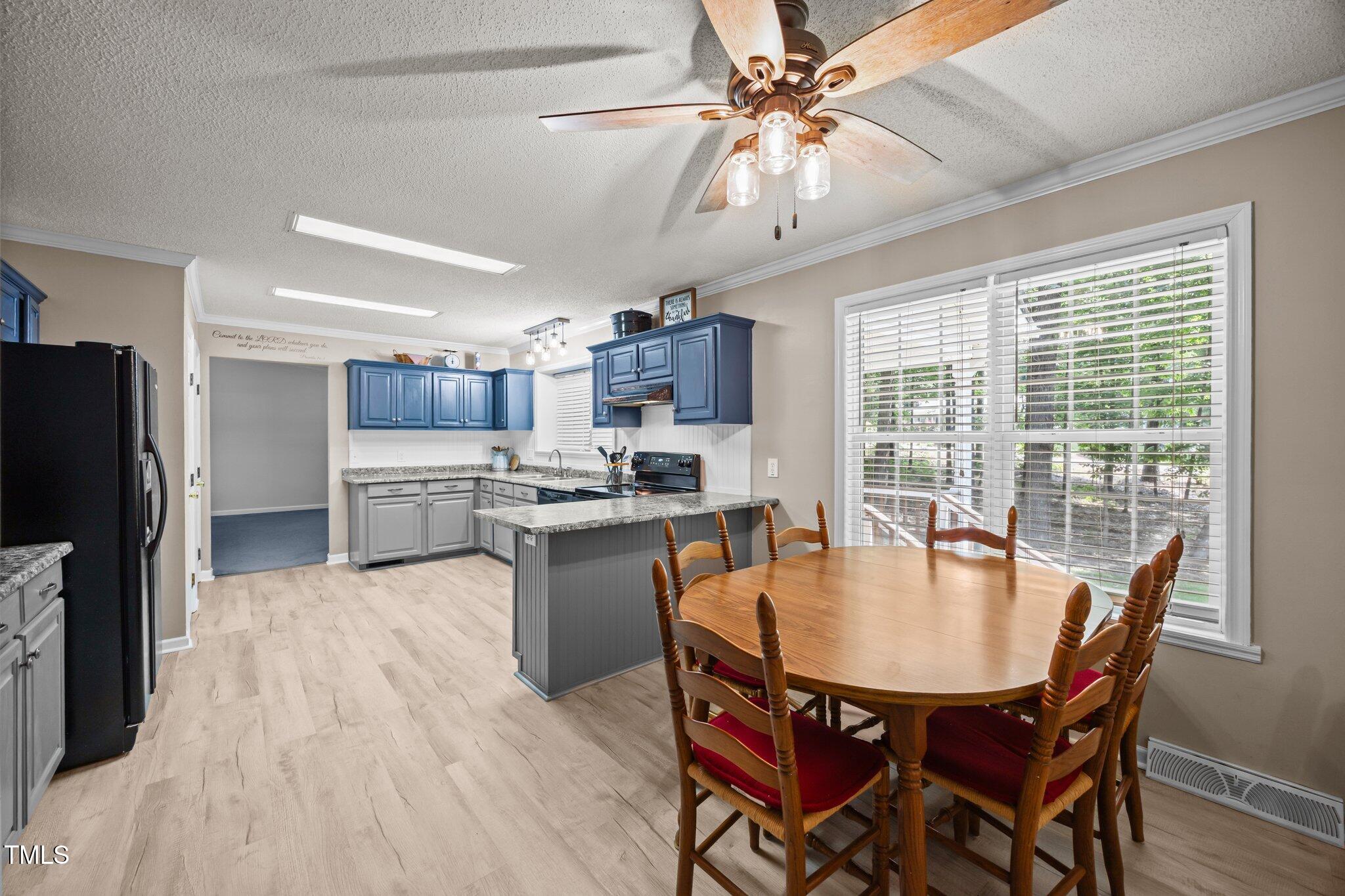 117 Lema Drive Garner, NC 27529 - Photo 15 of 34 a kitchen with stainless steel appliances granite countertop a stove a refrigerator a kitchen island a dining table and chairs