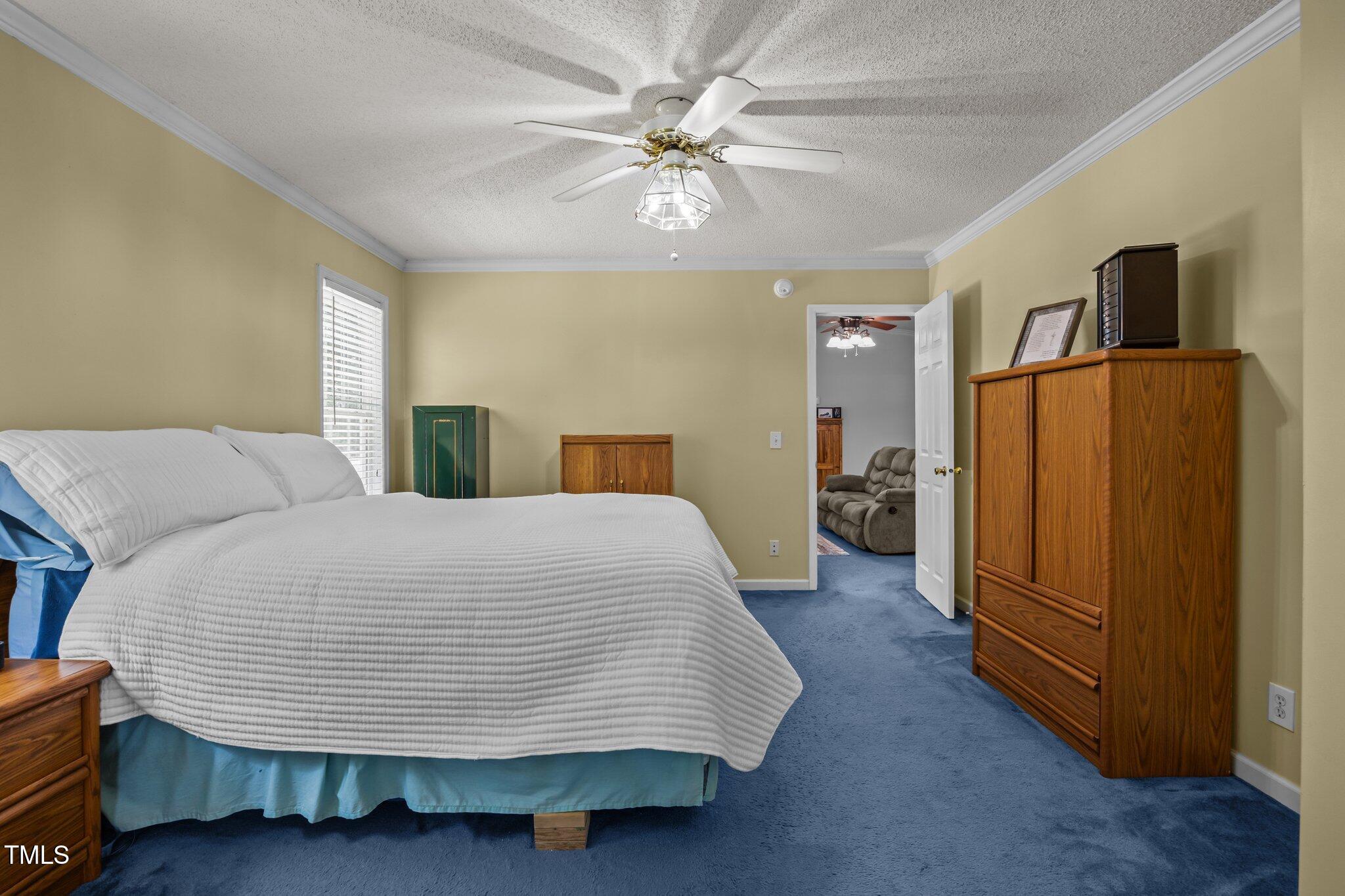 117 Lema Drive Garner, NC 27529 - Photo 19 of 34 a bedroom with a bed and dresser