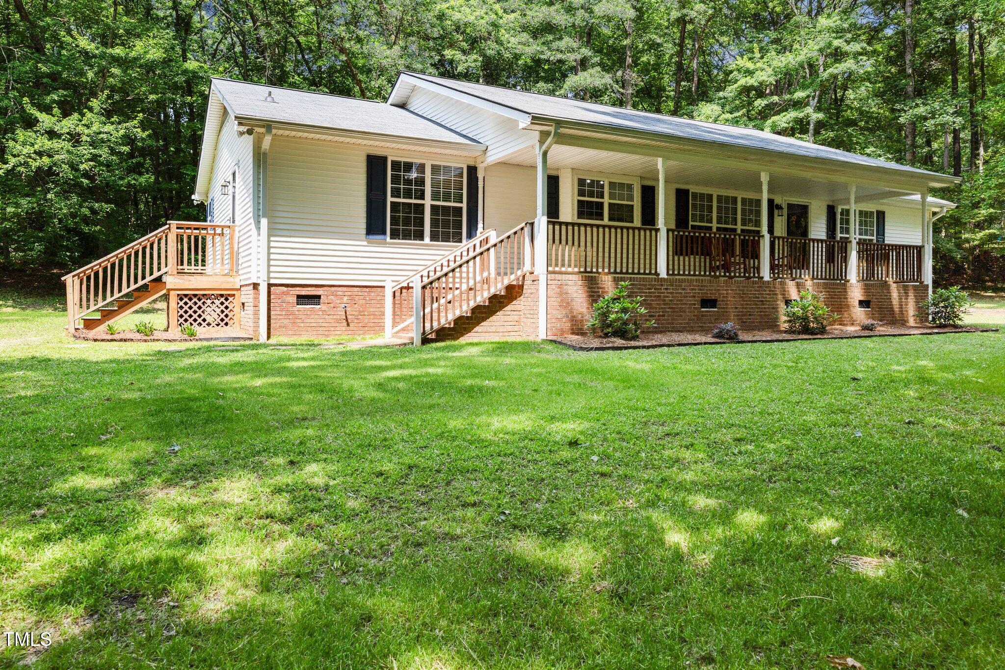 117 Lema Drive Garner, NC 27529 - Photo 30 of 34 a view of a house with a yard and deck