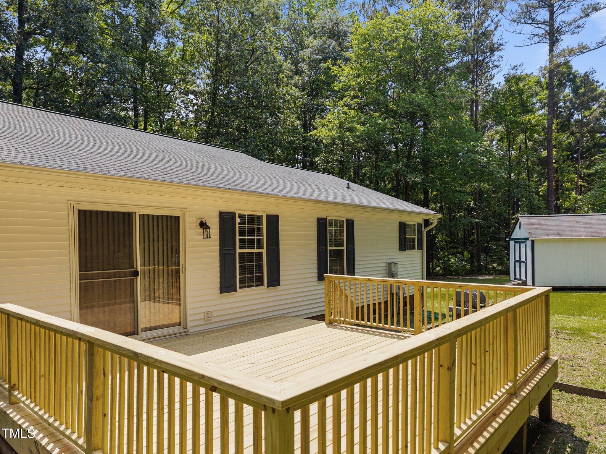 117 Lema Drive Garner, NC 27529 - Photo 32 of 34 a view of a house with pool and deck