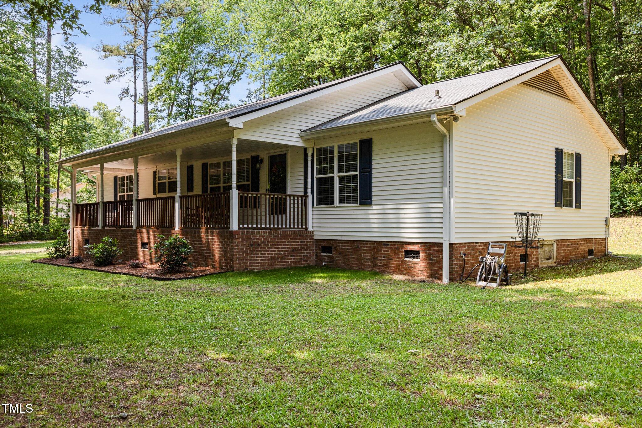 117 Lema Drive Garner, NC 27529 - Photo 3 of 34 a view of a house with a yard and a garden
