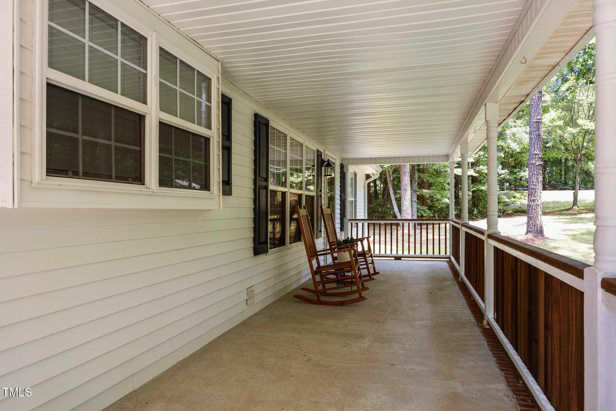 117 Lema Drive Garner, NC 27529 - Photo 4 of 34 a view of a porch with wooden floor and floor to ceiling window