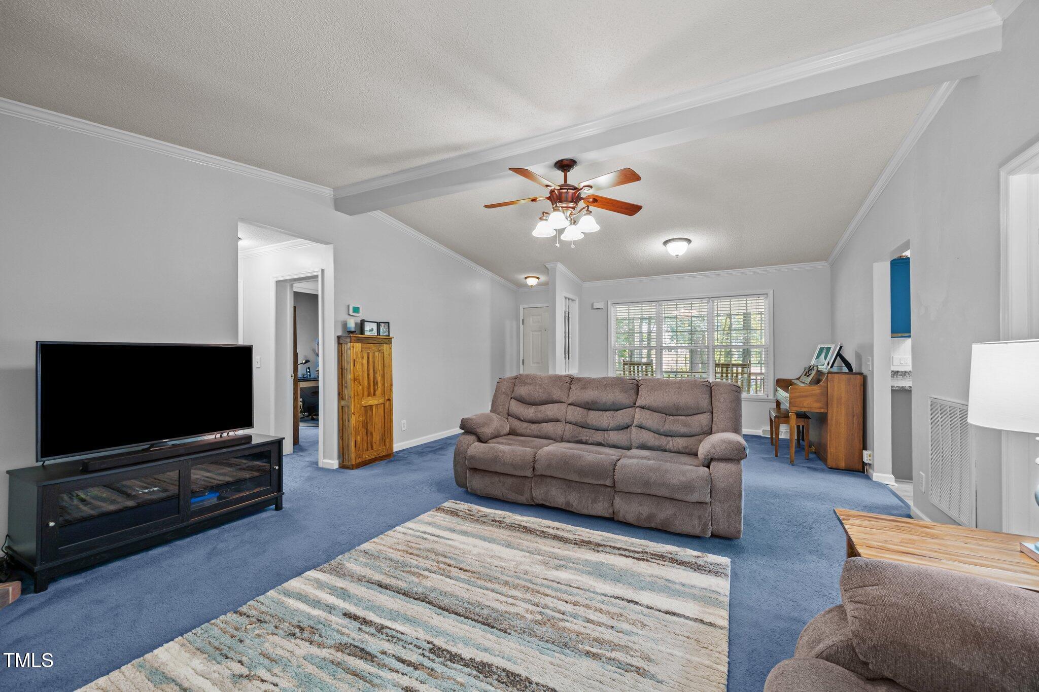 117 Lema Drive Garner, NC 27529 - Photo 8 of 34 a living room with furniture and a flat screen tv