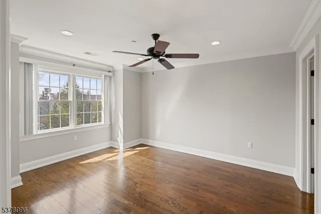 a view of a livingroom with a ceiling fan and window