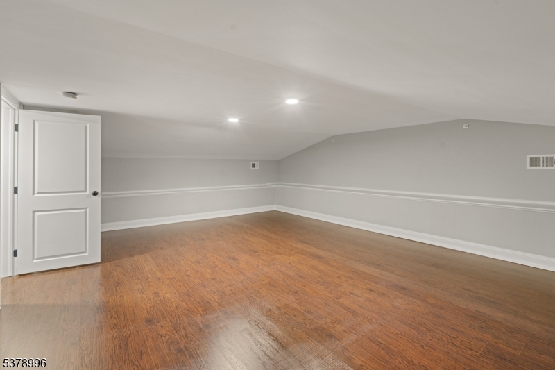 4 Central Avenue, Unit D Caldwell, NJ 07006 - Photo 15 of 32 a view of an empty room with a window and wooden floor