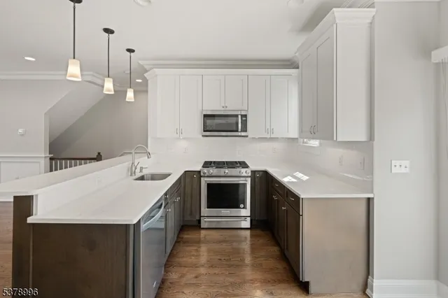 a kitchen with a sink stove and microwave