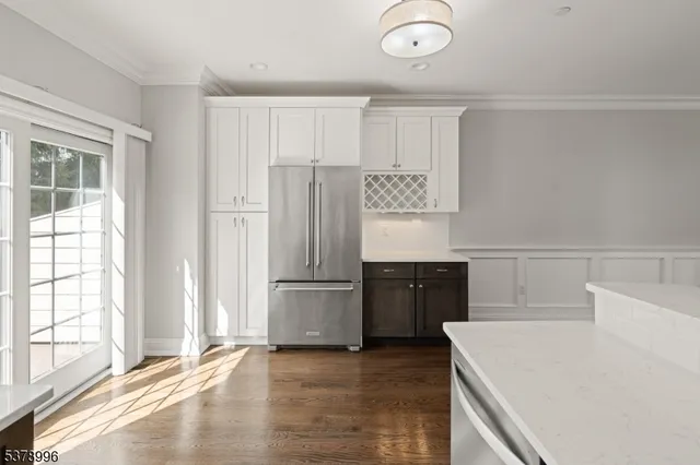 a kitchen with a refrigerator and a sink
