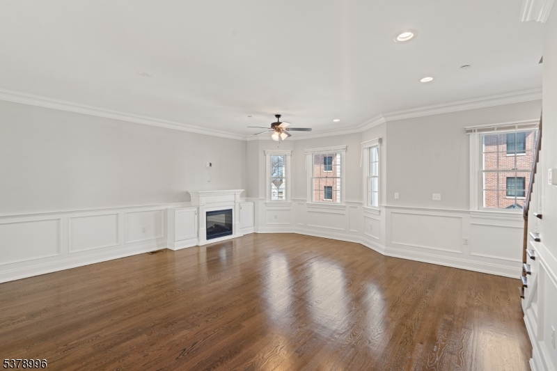 4 Central Avenue, Unit D Caldwell, NJ 07006 - Photo 9 of 32 a view of empty room with wooden floor and fireplace