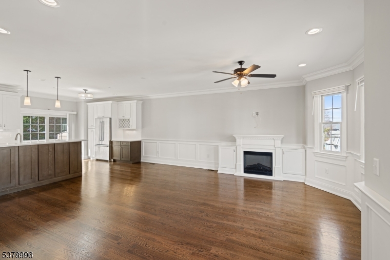 4 Central Avenue, Unit D Caldwell, NJ 07006 - Photo 10 of 32 a view of an empty room with wooden floor and a fireplace