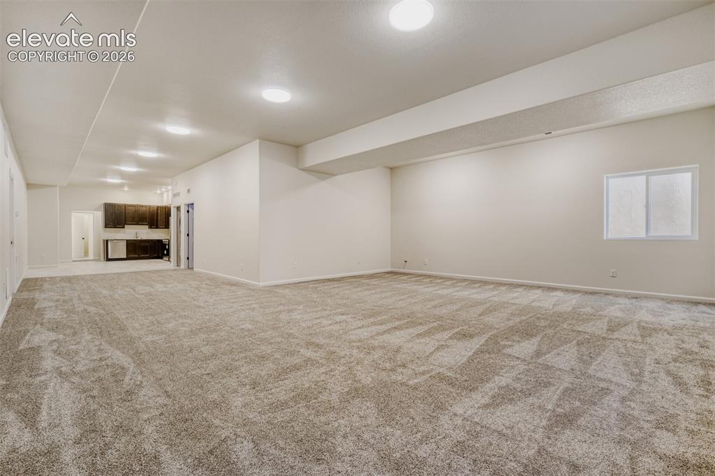 13680 Woodlake Road Elbert, CO 80106 - Photo 32 of 46 Basement family/game room with kitchenette and second laundry