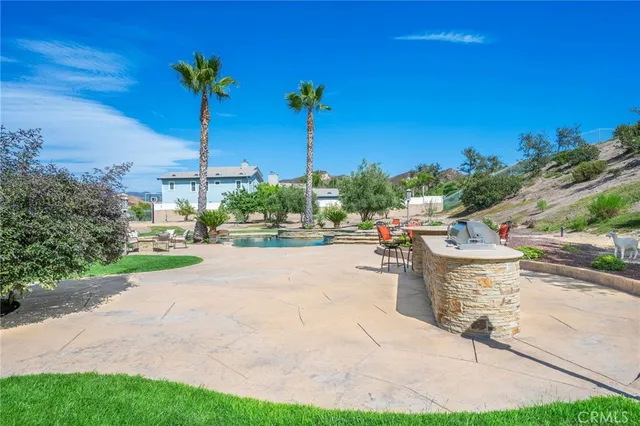 a view of a table and chairs under an umbrella