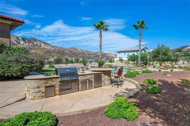 a view of a patio with a table and chairs under an umbrella