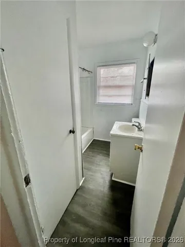 a view of a hallway to a livingroom with furniture