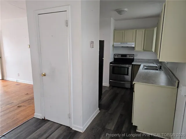 a kitchen with a refrigerator stove and cabinets