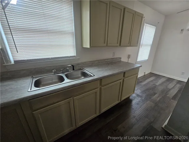 a kitchen with sink and cabinets