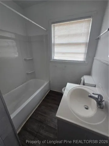 a bathroom with a sink toilet and mirror