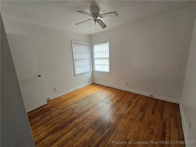 an empty room with wooden floor and closet