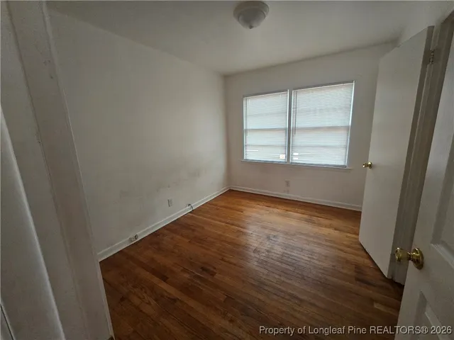 an empty room with wooden floor