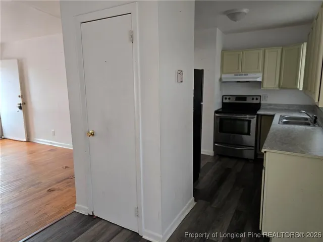 a kitchen with a refrigerator stove and cabinets