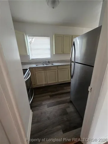 a kitchen with a refrigerator and a sink