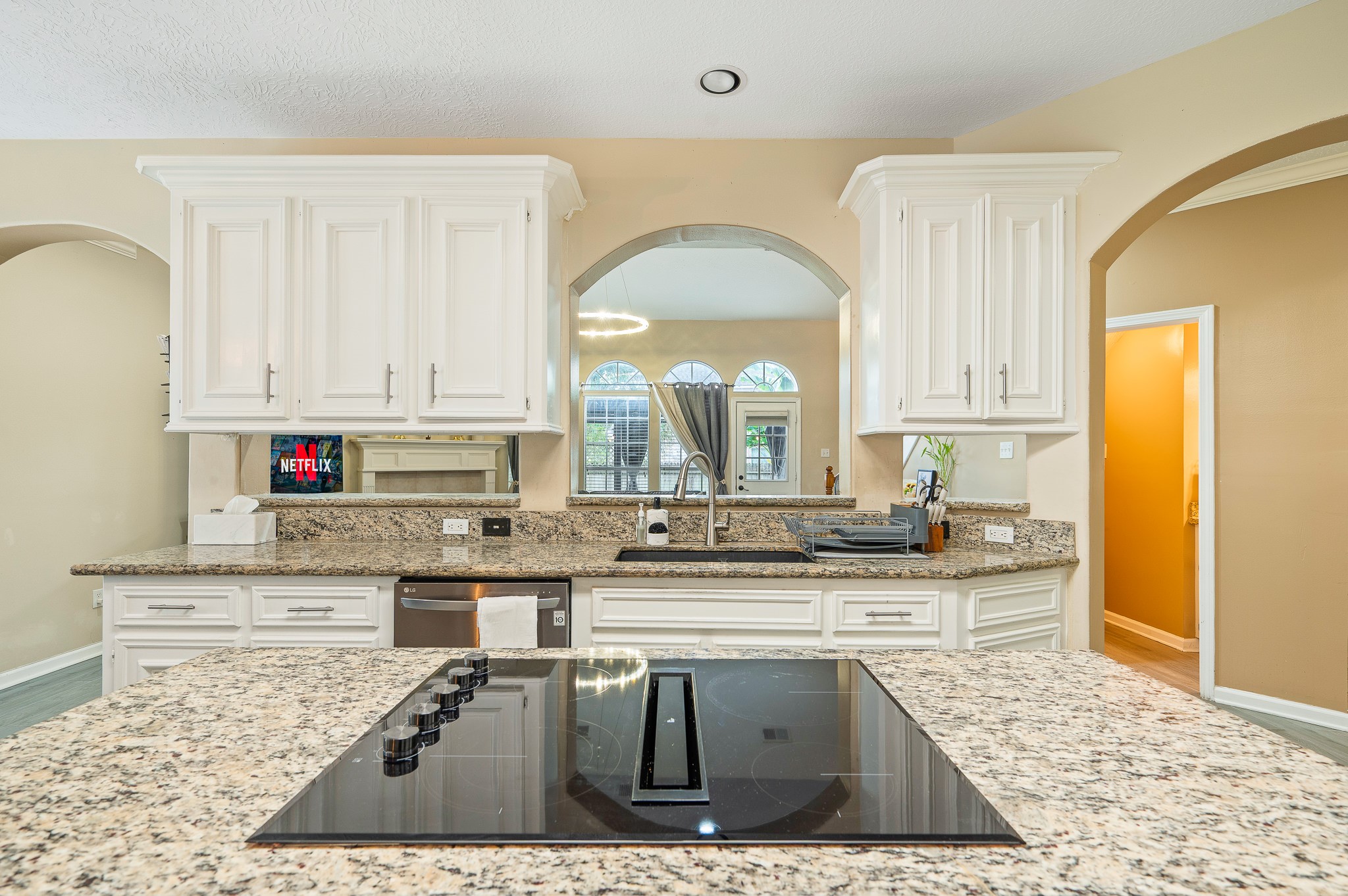 8111 Morningbrook Court Spring, TX 77379 - Photo 11 of 46 a kitchen with stainless steel appliances kitchen island granite countertop a stove and white cabinets