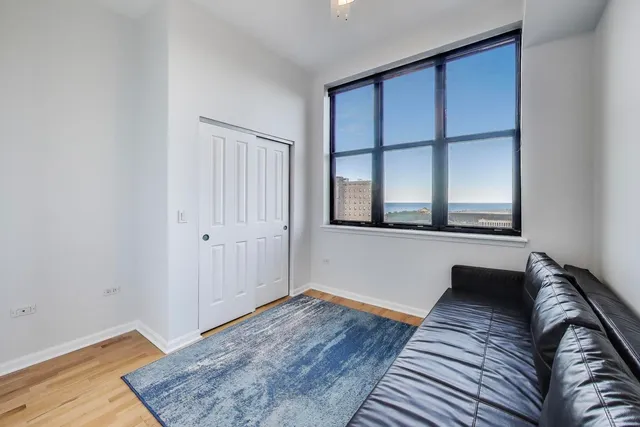 a living room with a bed and a window