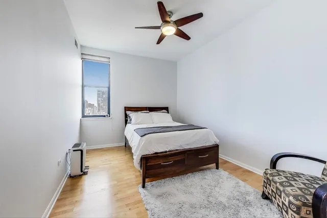 a bedroom with a bed and a window