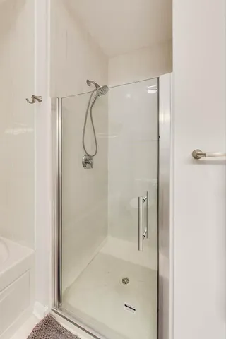 a bathroom with a glass shower door
