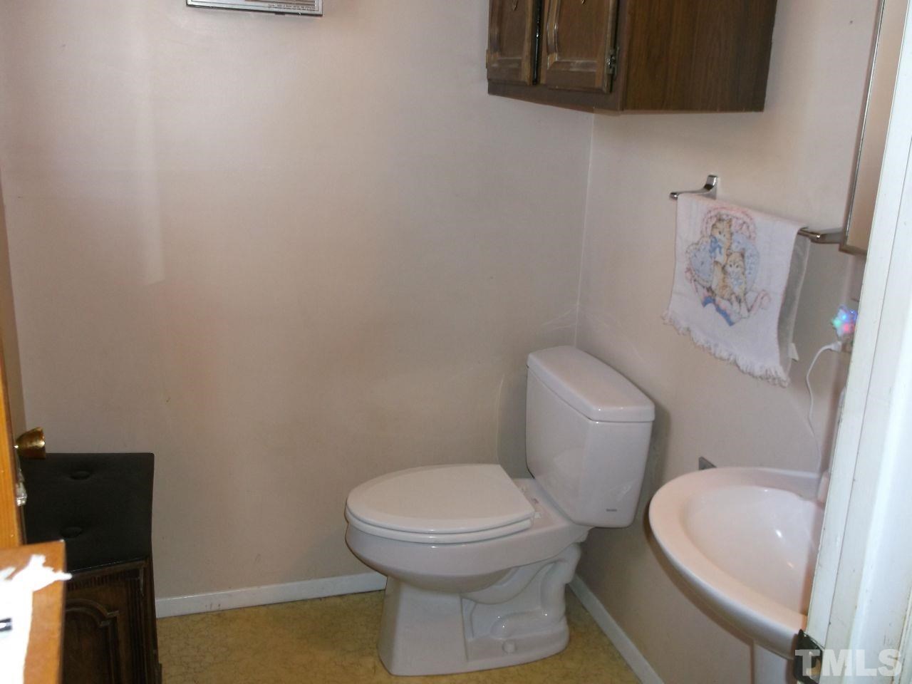 4904 Brown Road Rougemont, NC 27572 - Photo 8 of 18 a white toilet sitting next to a bathroom sink